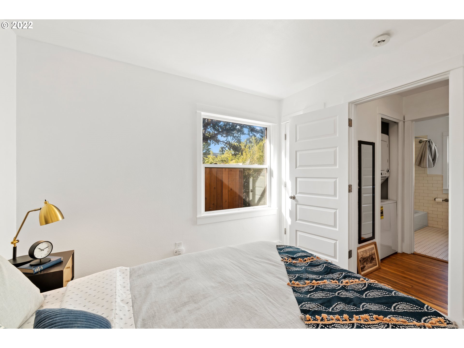 506 Northeast Rosa Parks Way, Unit 2 Portland, OR 97211 - Photo 9 of 17 a bedroom with a bed and a window