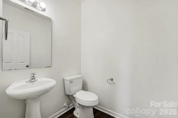 a bathroom with a sink a toilet and mirror