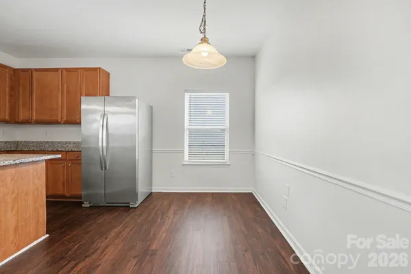 a view of a room with wooden floor cabinets and a window