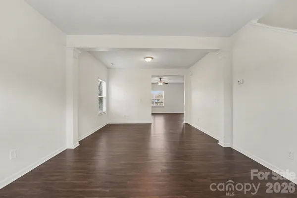 a view of an empty room and wooden floor