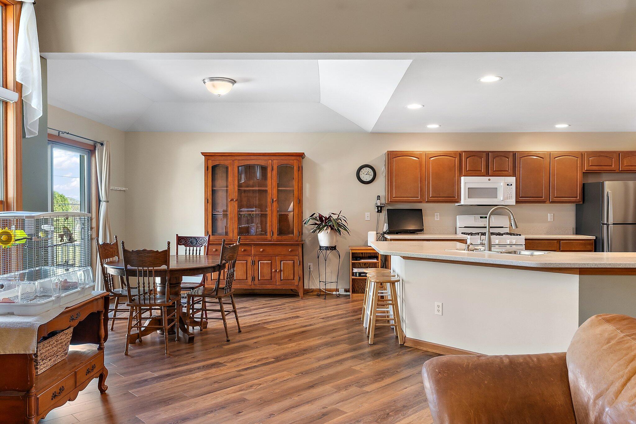 1636 Edith Way Crown Point, IN 46307 - Photo 15 of 56 a kitchen with stainless steel appliances kitchen island granite countertop a dining table chairs and granite counter tops