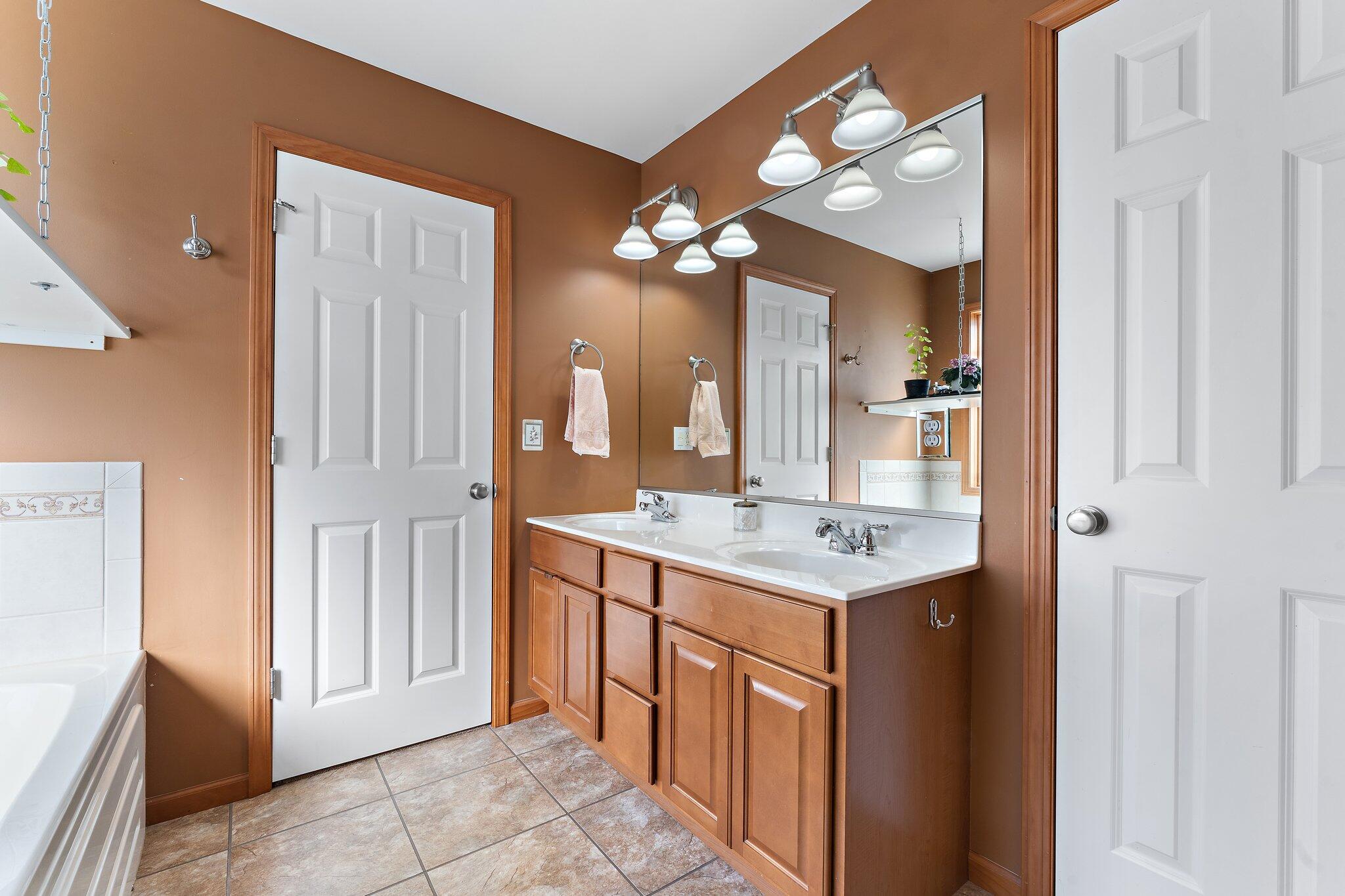 1636 Edith Way Crown Point, IN 46307 - Photo 26 of 56 a bathroom with a sink a light fixture and a mirror