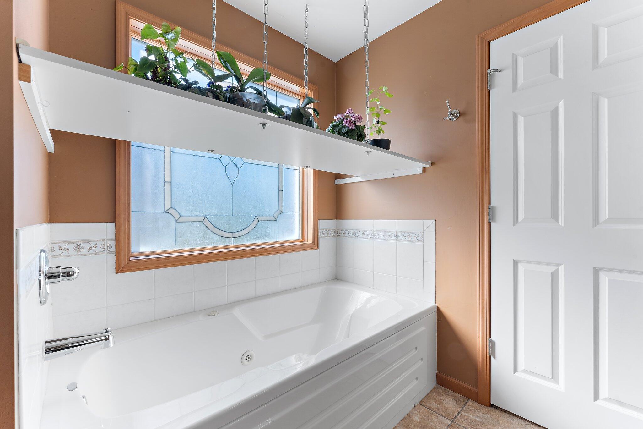 1636 Edith Way Crown Point, IN 46307 - Photo 27 of 56 a bathroom with a bathtub and a window