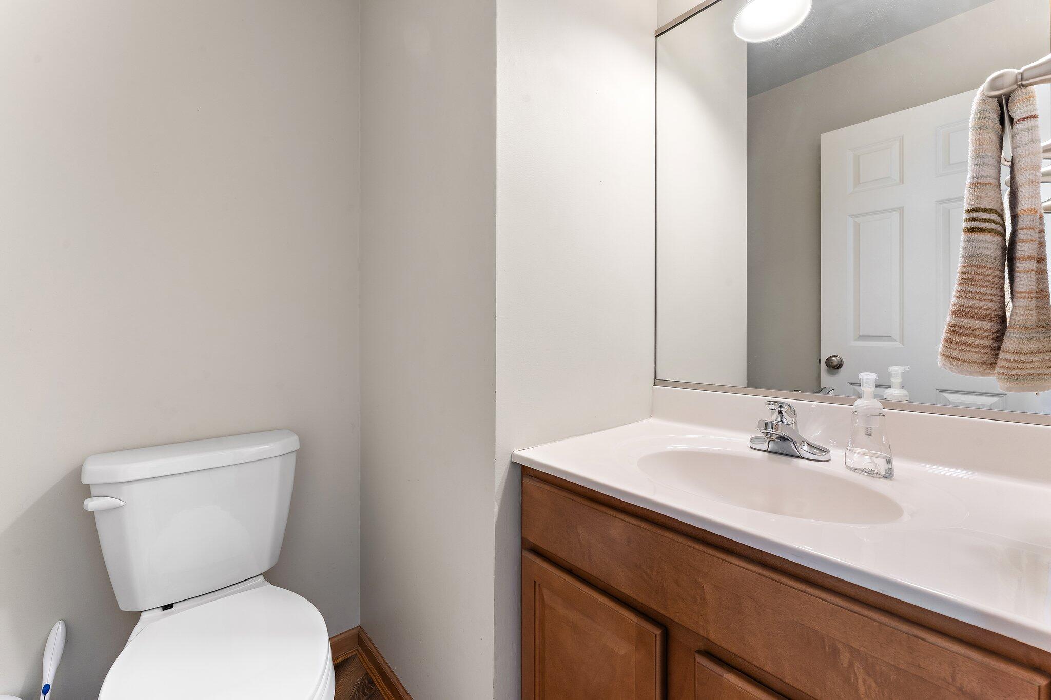 1636 Edith Way Crown Point, IN 46307 - Photo 45 of 56 a bathroom with a toilet sink and mirror