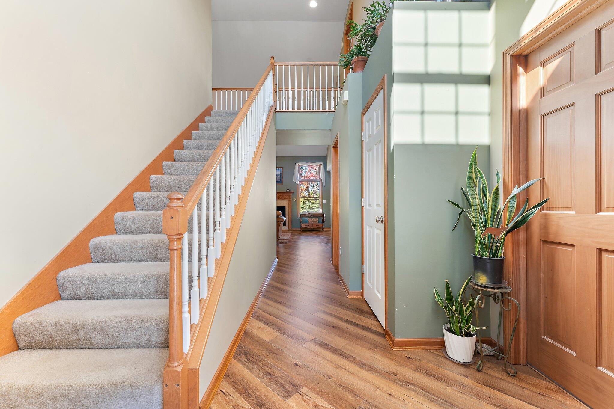 1636 Edith Way Crown Point, IN 46307 - Photo 9 of 56 a view of staircase with wooden floor and a potted plant