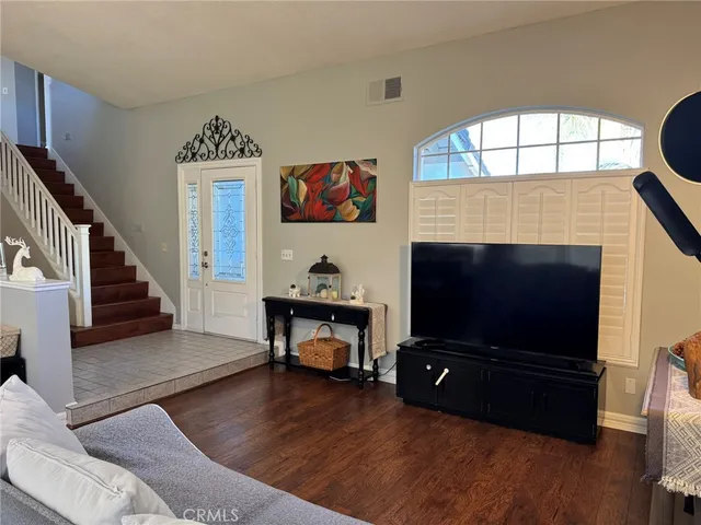 a living room with furniture flat screen tv and a fireplace