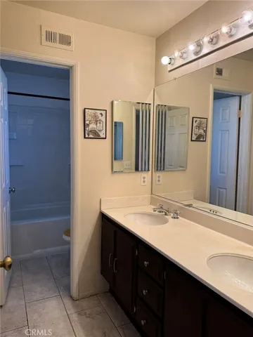 a bathroom with a sink double vanity and a mirror