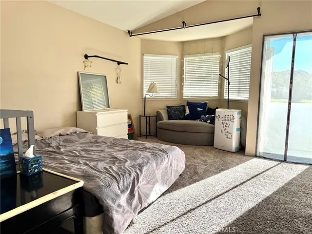 a bedroom with a bed window and a couch