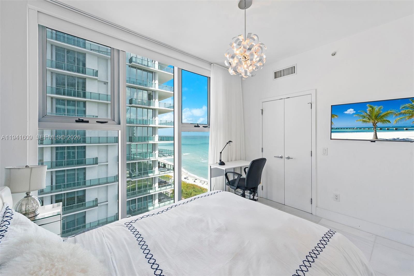 6899 Collins Avenue, Unit 1205 Miami Beach, FL 33141 - Photo 16 of 48 a bedroom with a bed and a window