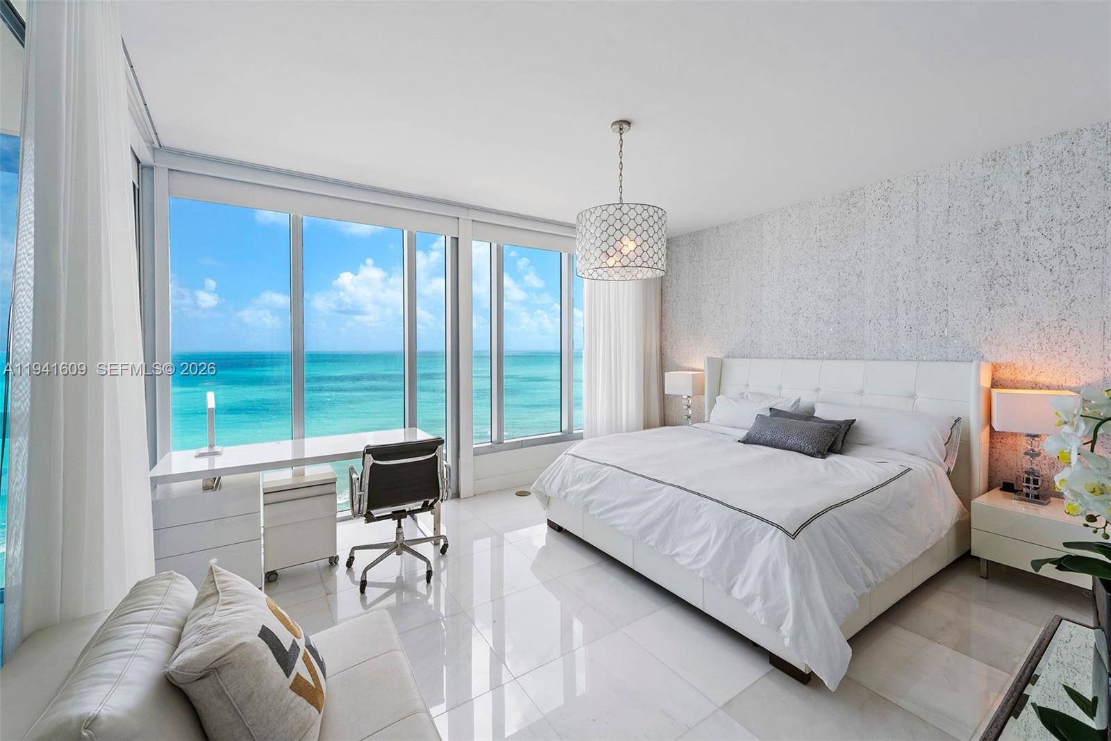 6899 Collins Avenue, Unit 1205 Miami Beach, FL 33141 - Photo 2 of 48 a bedroom with a bed and a large window