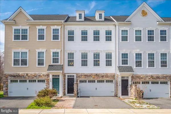 a front view of a building with a garden