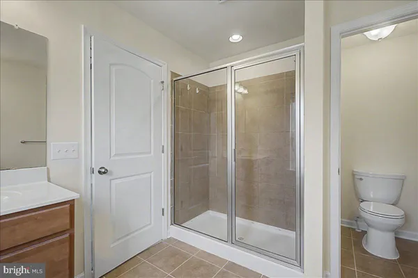 a bathroom with a shower a toilet and a sink