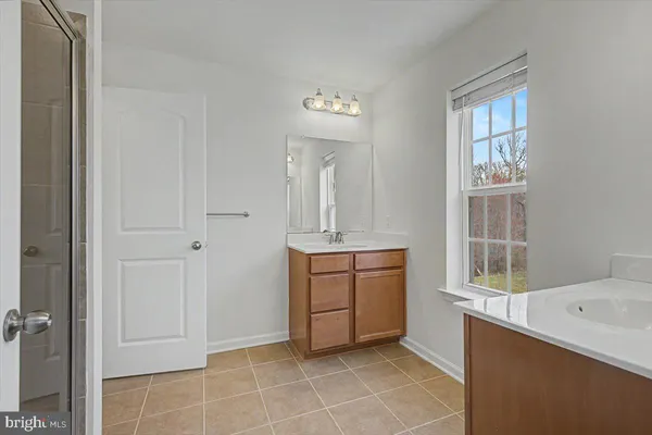 a room that has a mirror and a sink in it
