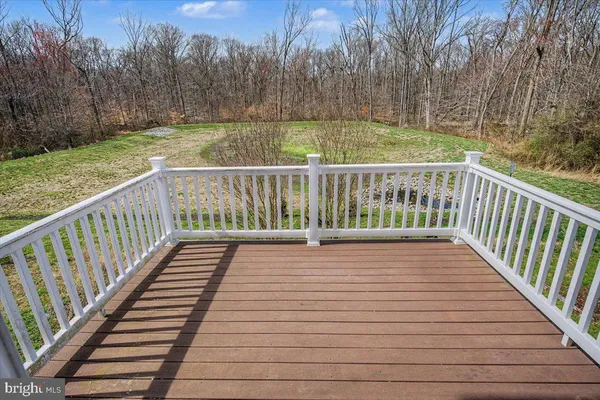 a view of balcony with wooden floor and fence