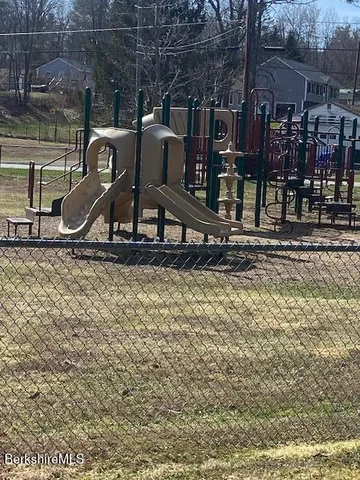 a view of a yard with snow on the road