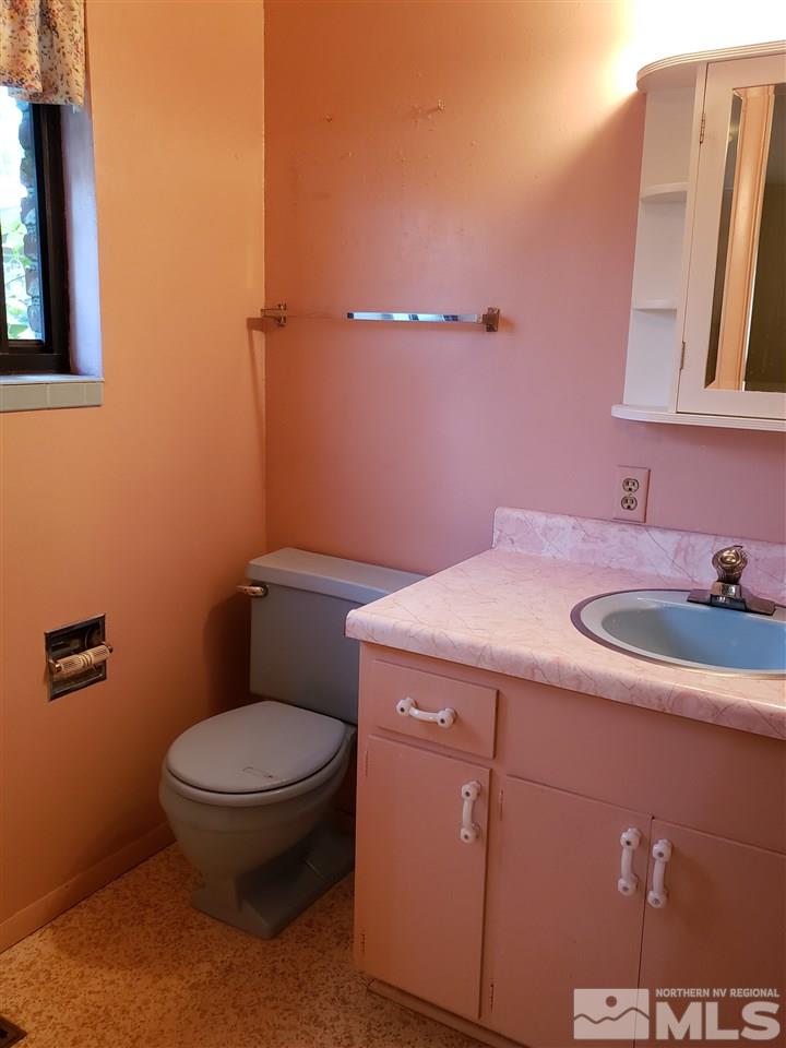 1120 Alpine Circle Reno, NV 89509 - Photo 11 of 21 a bathroom with a sink a toilet and mirror
