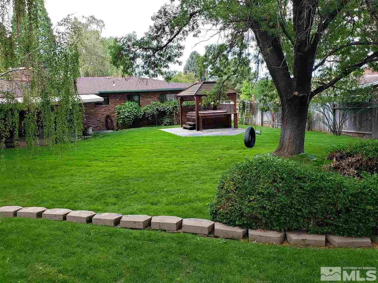 1120 Alpine Circle Reno, NV 89509 - Photo 15 of 21 a view of a garden with lawn chairs and a large tree