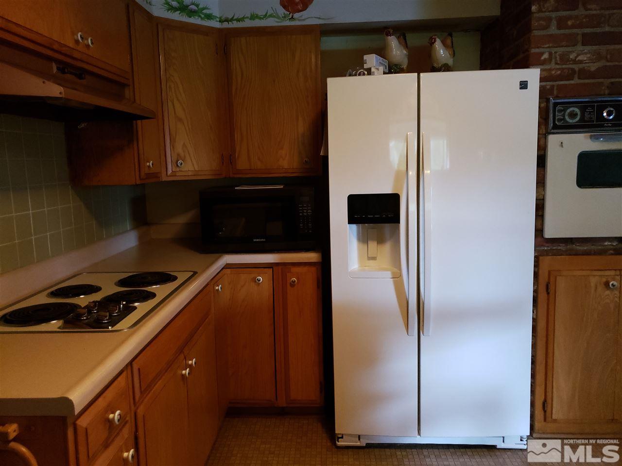1120 Alpine Circle Reno, NV 89509 - Photo 4 of 21 a white refrigerator freezer and a stove sitting inside of a kitchen