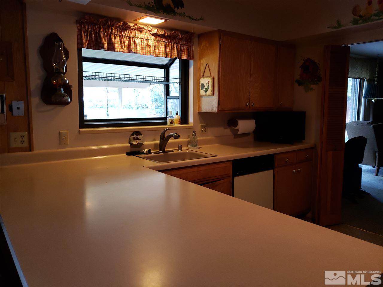 1120 Alpine Circle Reno, NV 89509 - Photo 5 of 21 a room with wooden floor and windows
