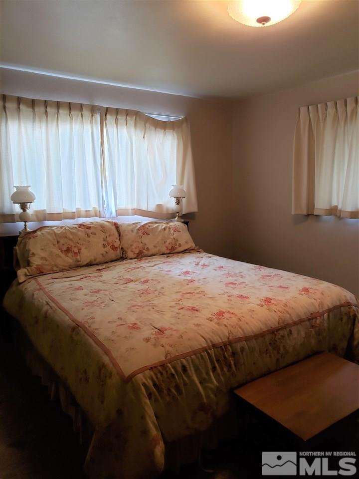 1120 Alpine Circle Reno, NV 89509 - Photo 8 of 21 a bedroom with a bed a table and chair