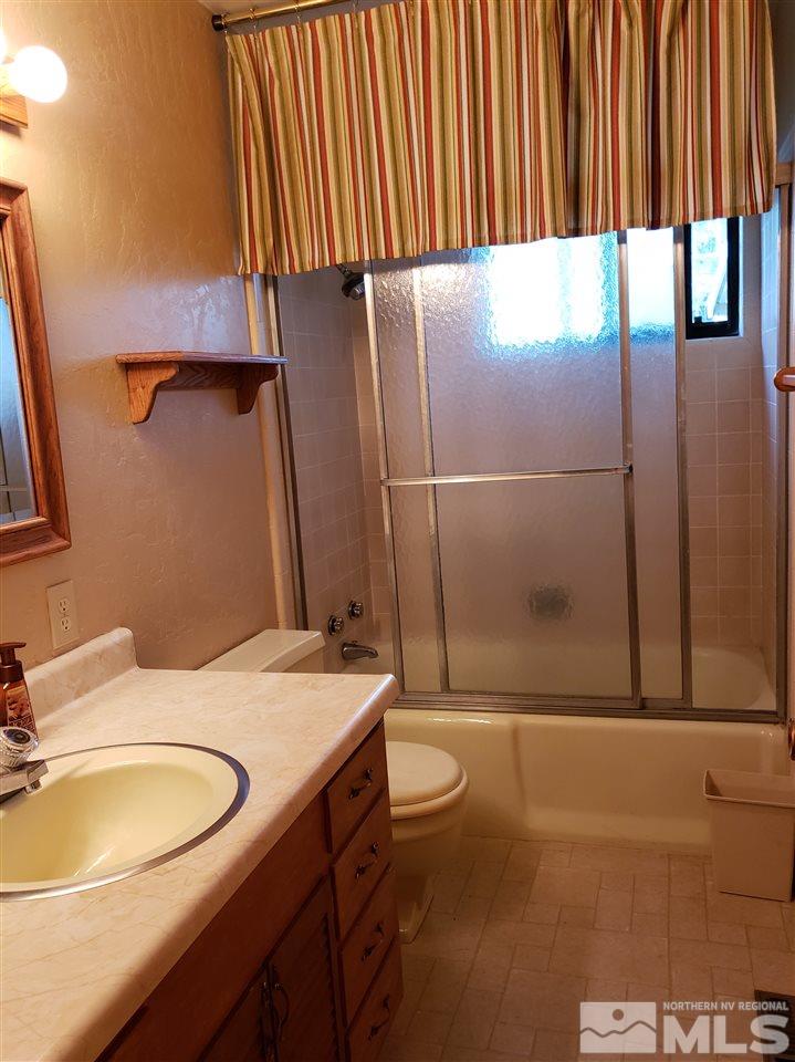 1120 Alpine Circle Reno, NV 89509 - Photo 9 of 21 a bathroom with a sink toilet and shower