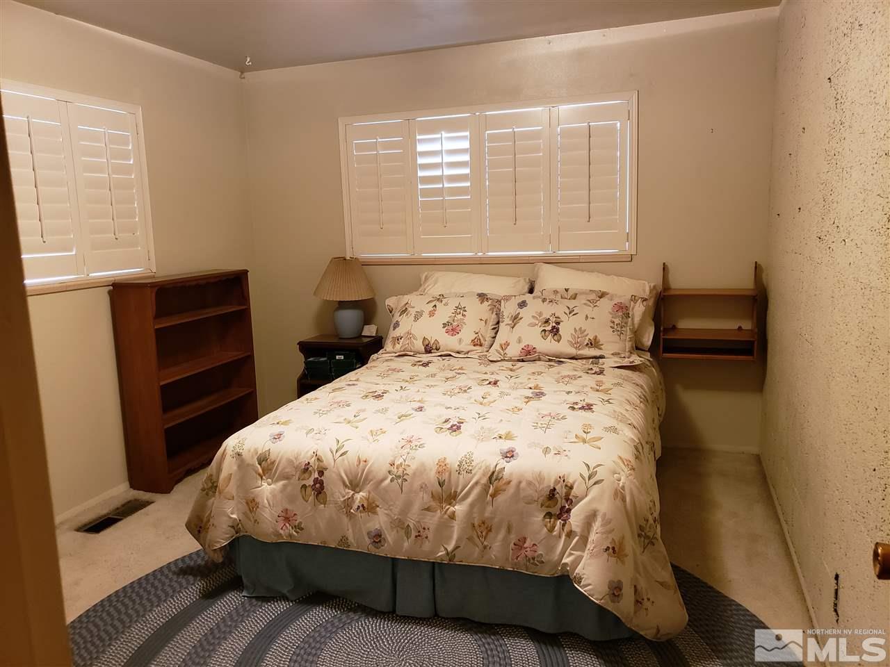 1120 Alpine Circle Reno, NV 89509 - Photo 10 of 21 a bedroom with a bed and wooden floor
