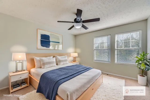 a bedroom with a large bed and a window