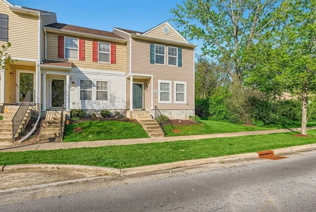 a front view of a house with a yard and a garage