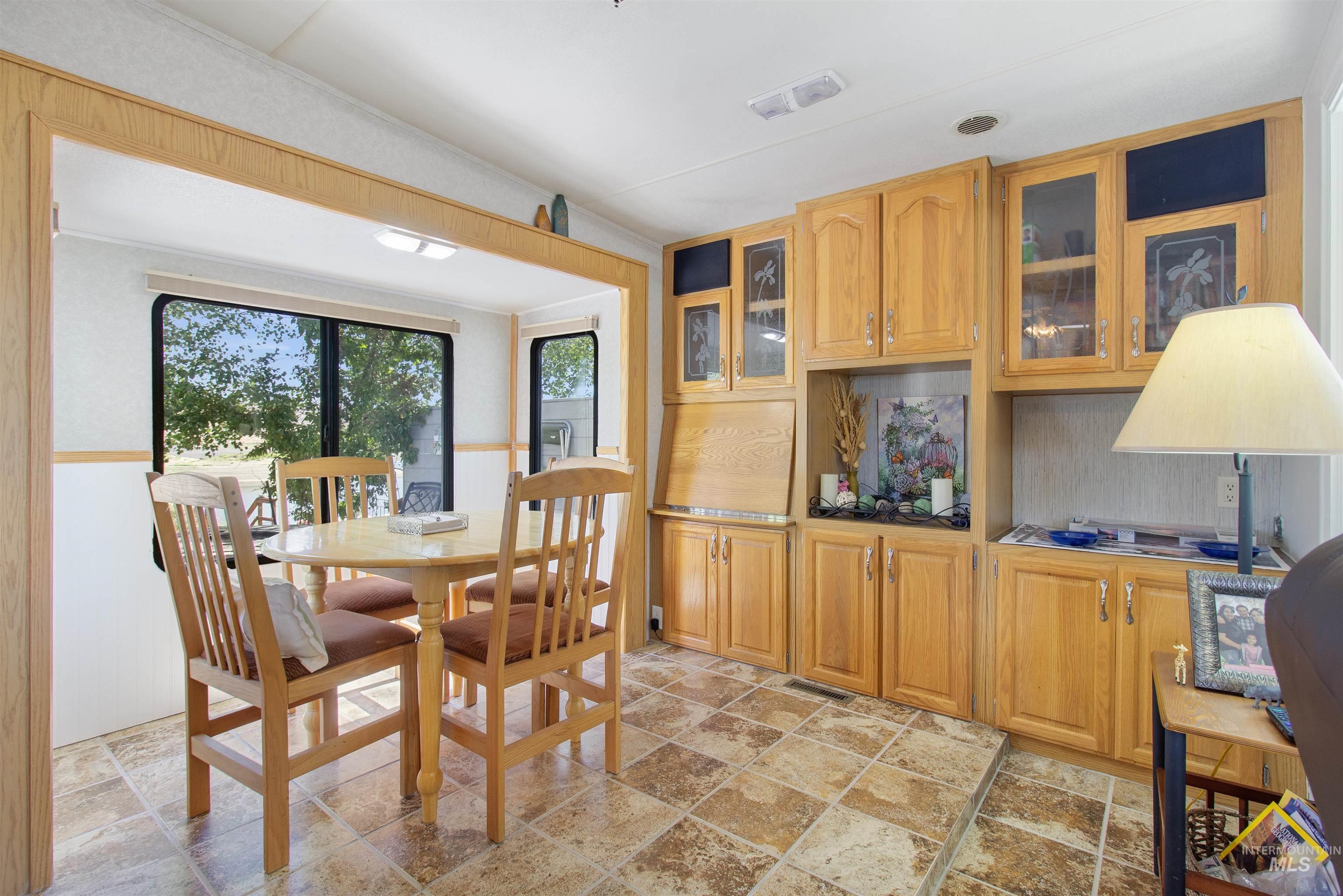 106 West Magic Road Shoshone, ID 83352 - Photo 16 of 45 Built-in cabinetry with glass-front uppers and a desk hutch complement the tiled flooring