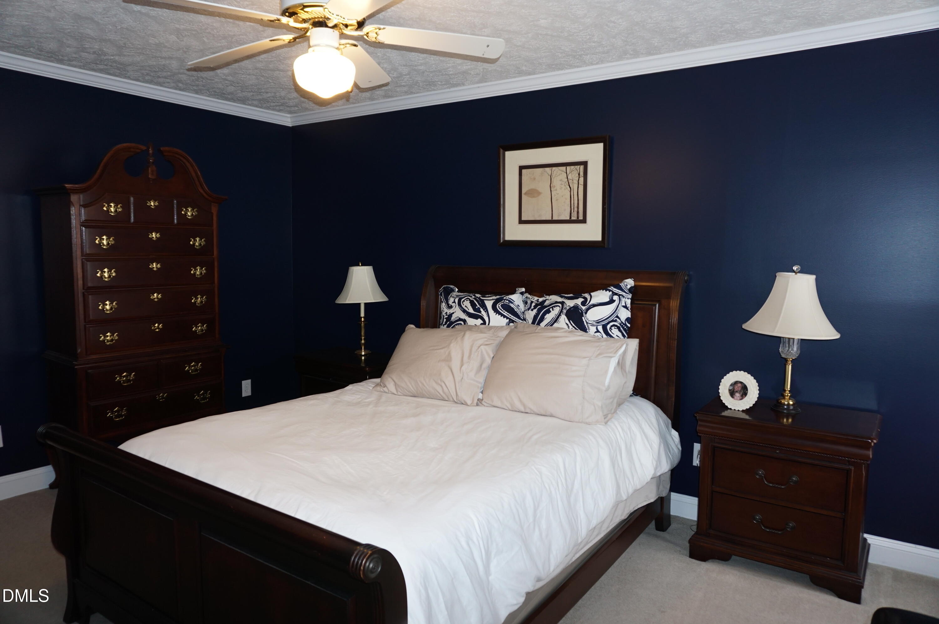 2125 Keith Hills Road Lillington, NC 27546 - Photo 42 of 66 a bedroom with a bed and a lamp on dresser