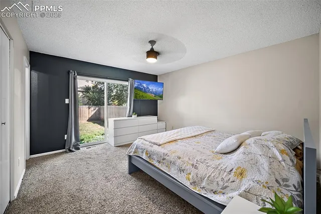 a spacious bedroom with a bed and a large window