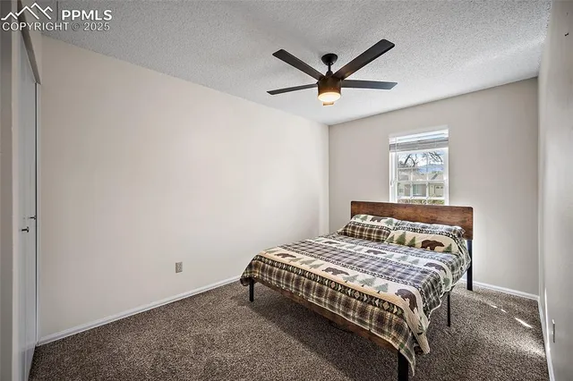 a bedroom with a bed a window and a chandelier
