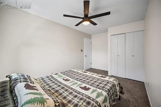 a bedroom with a bed and a ceiling fan