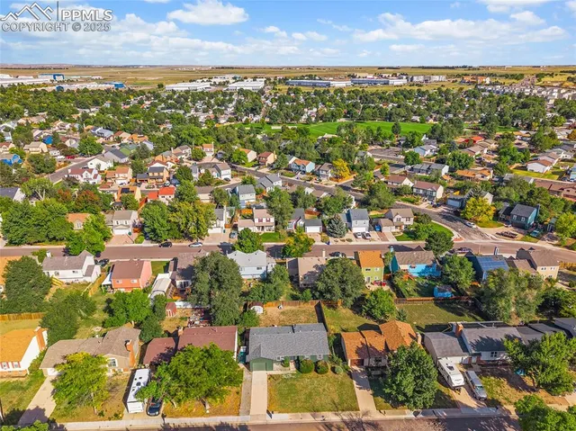 an aerial view of residential houses with city view
