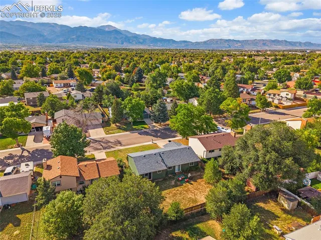 an aerial view of residential houses with outdoor space and street view