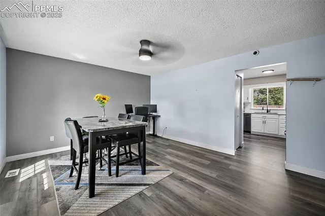 a view of a dining room with furniture and wooden floor