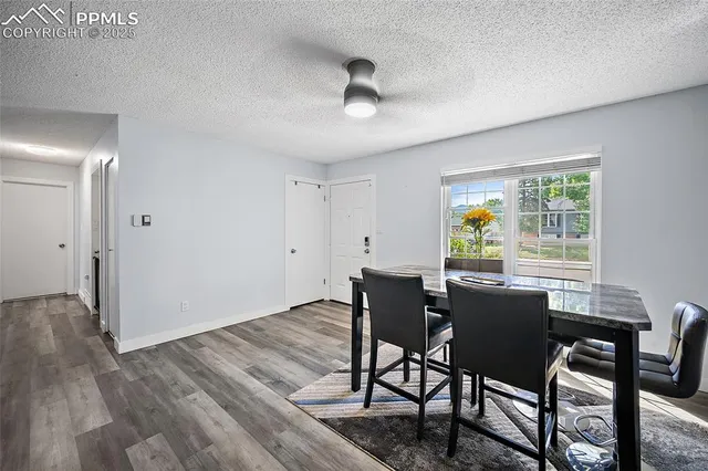 a view of a dining room with furniture and a window