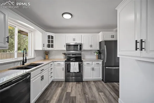 a kitchen with a refrigerator stove and sink