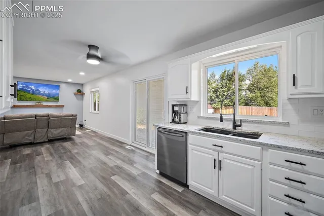 a kitchen with sink cabinets and window