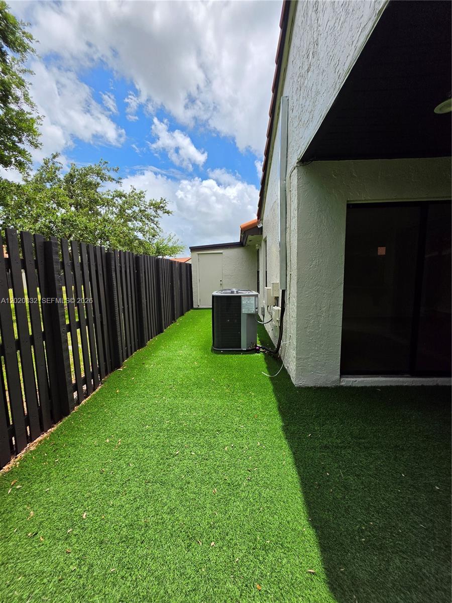 15240 Southwest 45th Terrace, Unit 54F Miami, FL 33185 - Photo 46 of 48 a view of a backyard with wooden fence