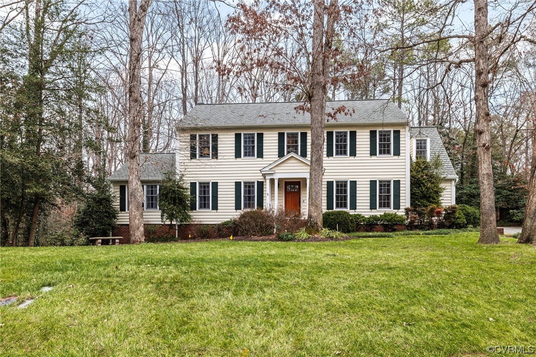 8920 Cardiff Road North Chesterfield, VA 23236 - Photo 3 of 36 a front view of a house with a garden and trees