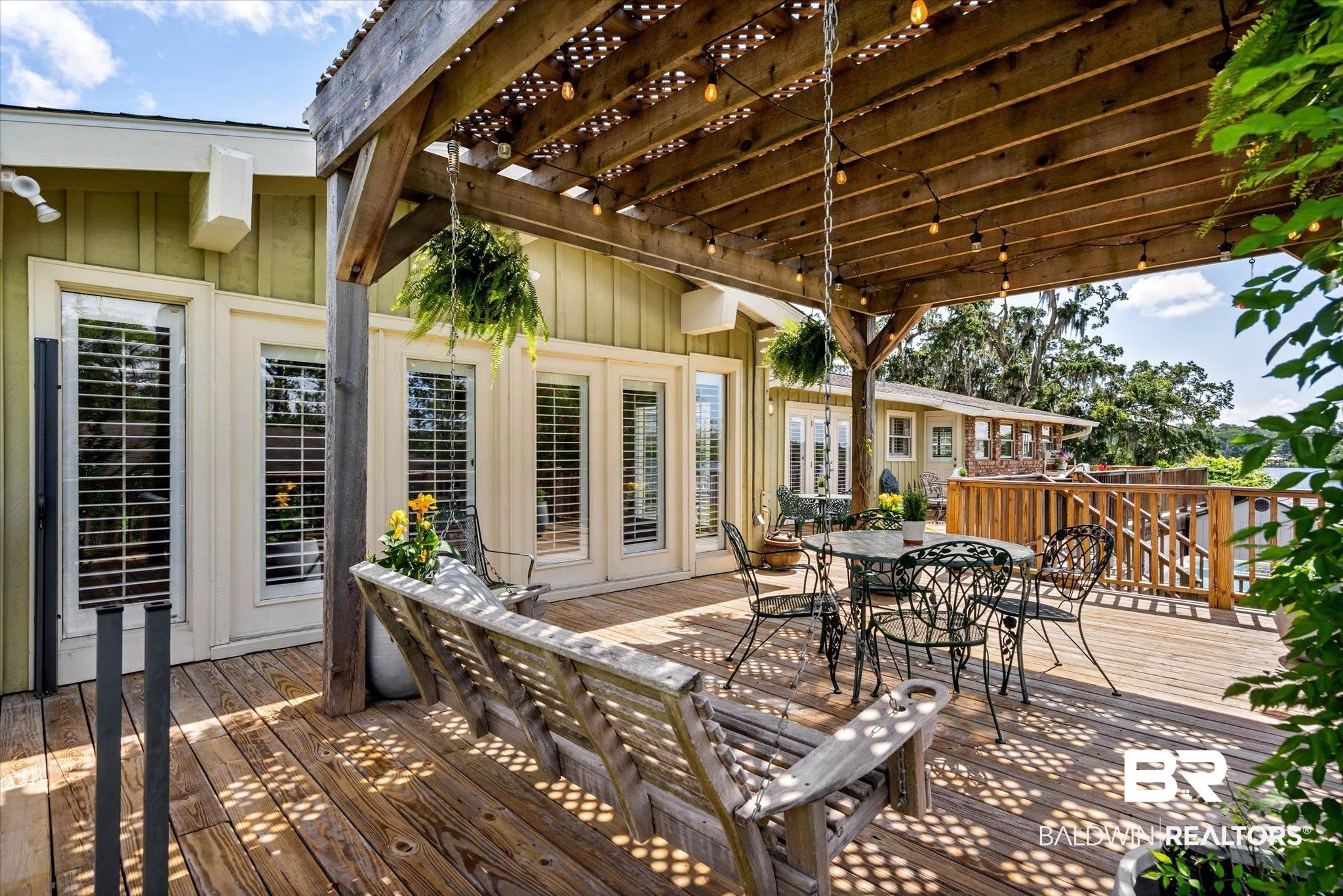 3801 Point Road Mobile, AL 36619 - Photo 34 of 55 Expansive wood deck with a pergola featuring string lights