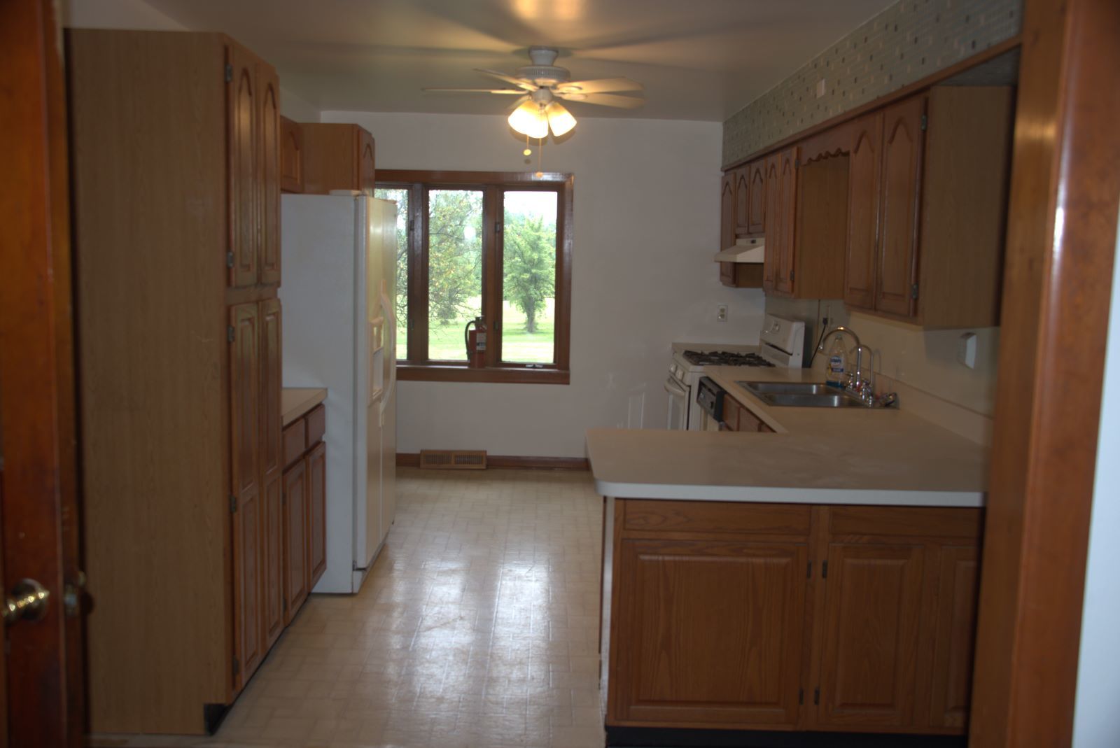 1921 East Steger Road Crete, IL 60417 - Photo 9 of 29 a view of a hallway with windows and chandelier