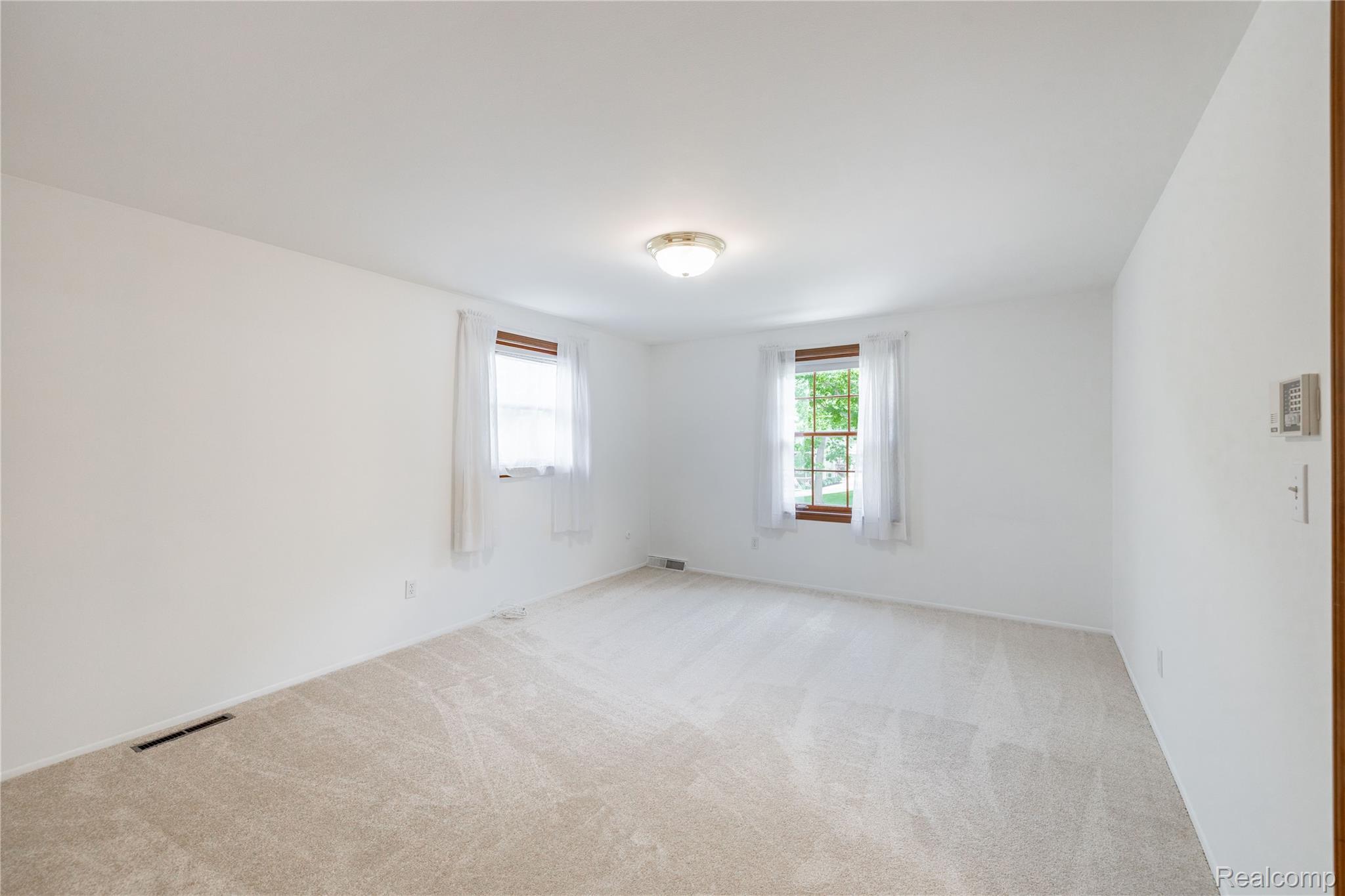 7611 Ferry Road Grosse Ile, MI 48138 - Photo 33 of 51 Light-filled interior space featuring two windows with wood trim