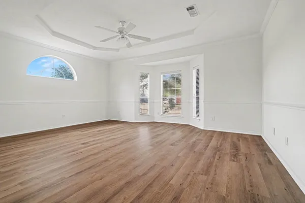 wooden floor in an empty room with a window