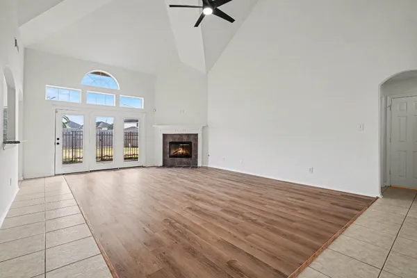 a view of empty room with fireplace and fan
