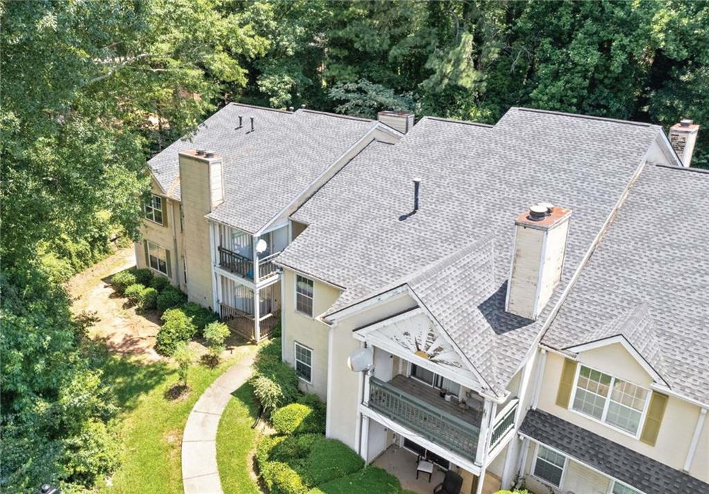 an aerial view of a house with a yard
