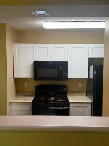 a kitchen with a stove and a microwave