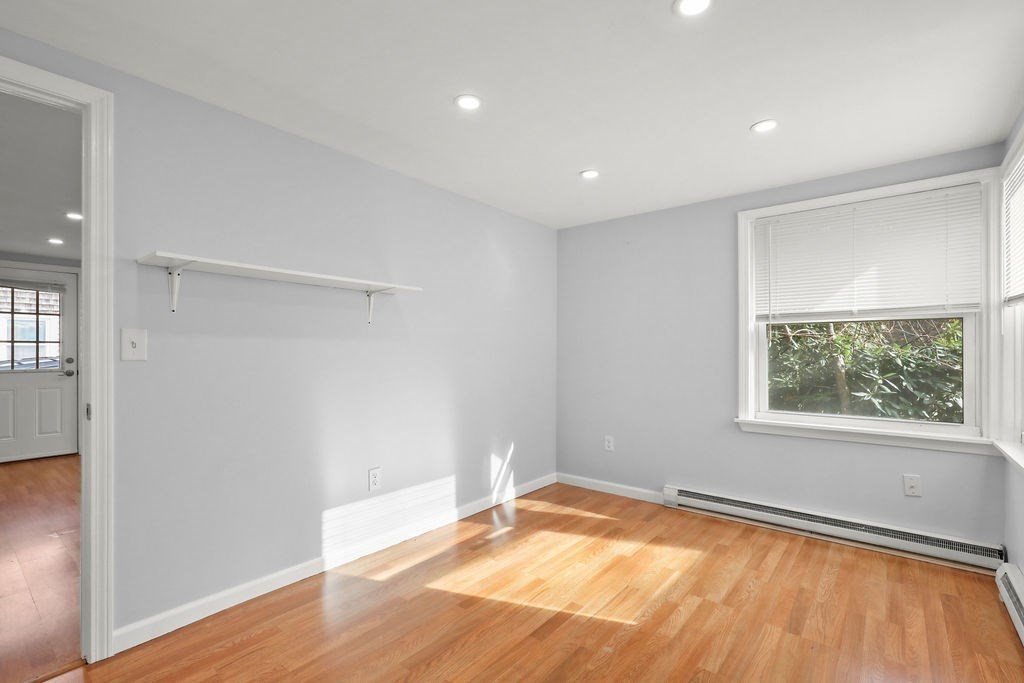 2705 State Highway Eastham, MA 02642 - Photo 12 of 42 an empty room with wooden floor and windows