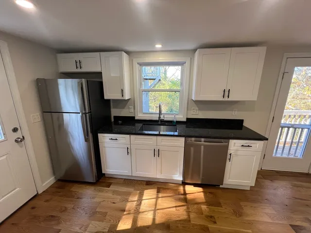 a kitchen with stainless steel appliances a refrigerator sink and microwave